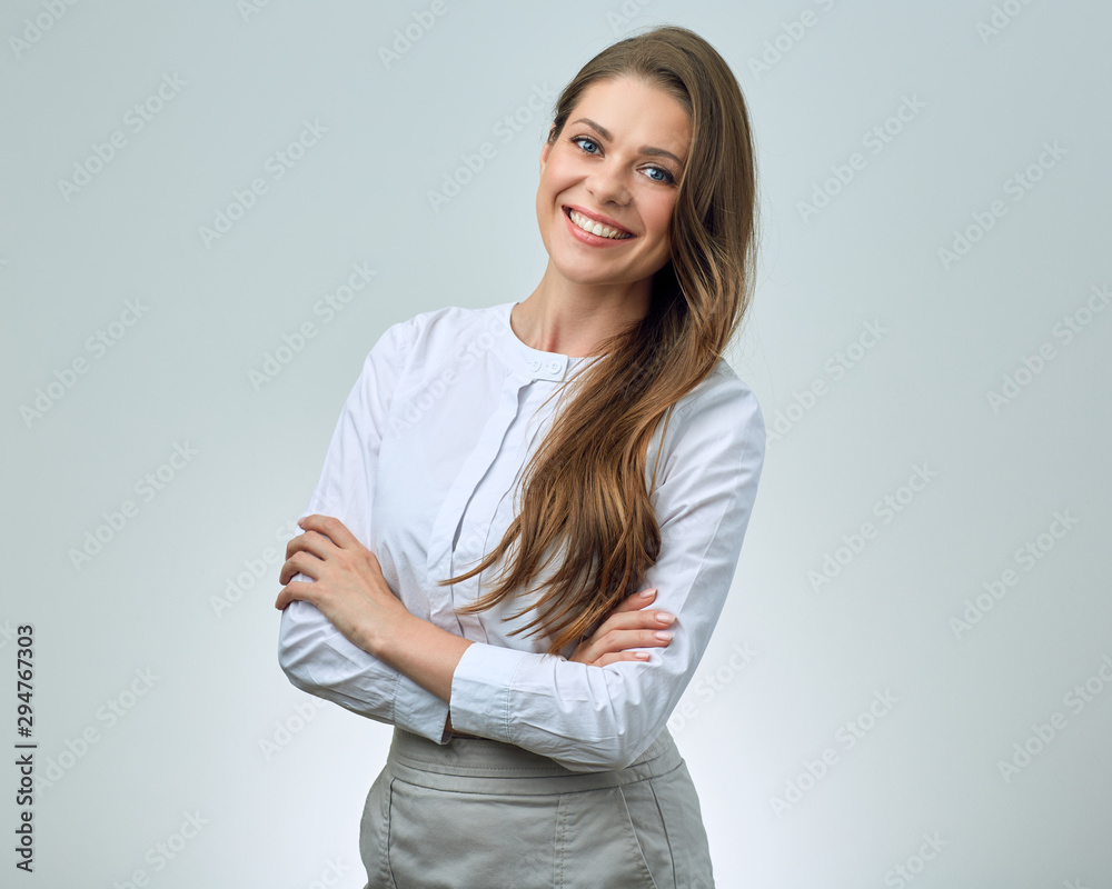 Smiling woman in white shirt posing with crossed arms. Smiling woman in white shirt posing with crossed arms.