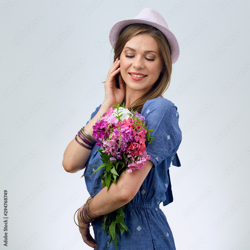 beautiful woman with flowers touching face. beautiful woman with flowers touching face.