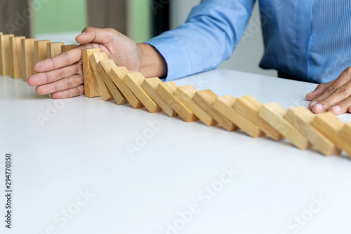 young business people use the hand to Stop wooden brick