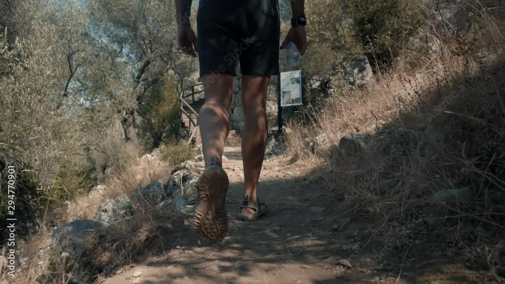 Man Walking In Ancient City.Hiking In Forest.Man Exploring Old Town In Turkey.Beautiful Tourist Walking Along Trail On Greek Ancient Town Amos.Attractive Male Model Walks With Backpack Man Walking In Ancient City.Hiking In Forest.Man Exploring Old Town In Turkey.Beautiful Tourist Walking Along Trail On Greek Ancient Town Amos.Attractive Male Model Walks With Backpack