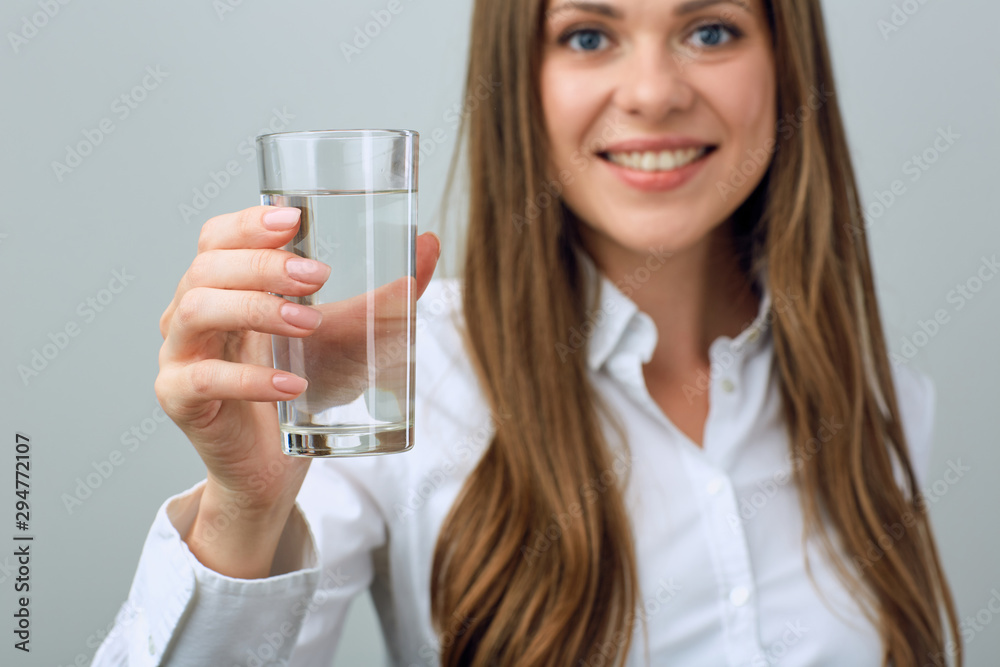 Young woman in white shirt holding water glass. Young woman in white shirt holding water glass.