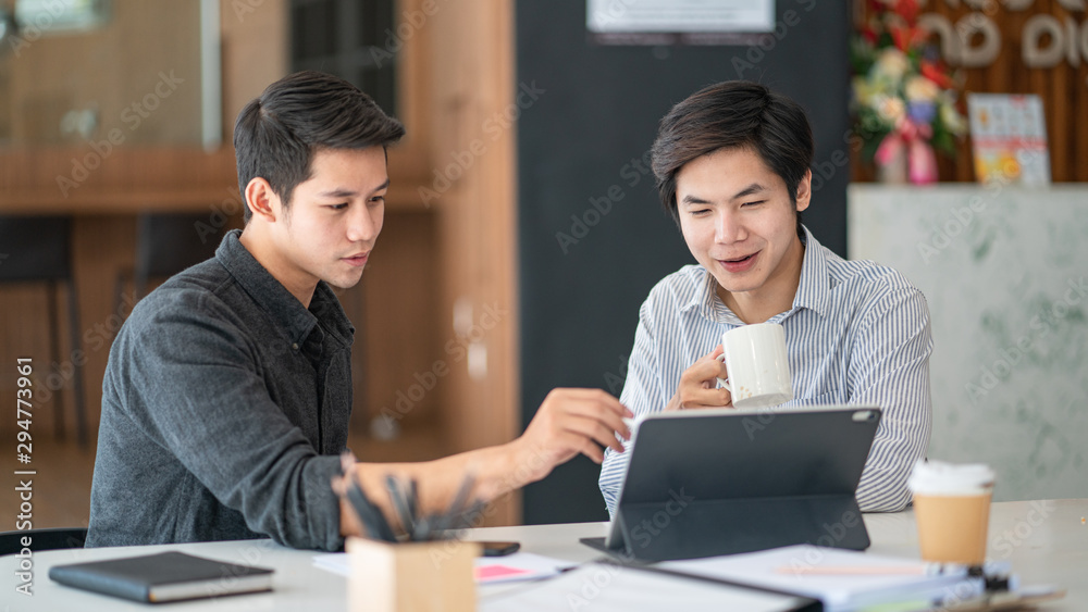 Young business colleagues talking with digital tablet in modern office. Young business colleagues talking with digital tablet in modern office.