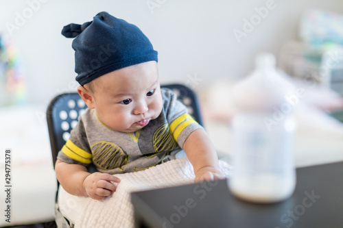 Cute baby boy drinking from bottle photo