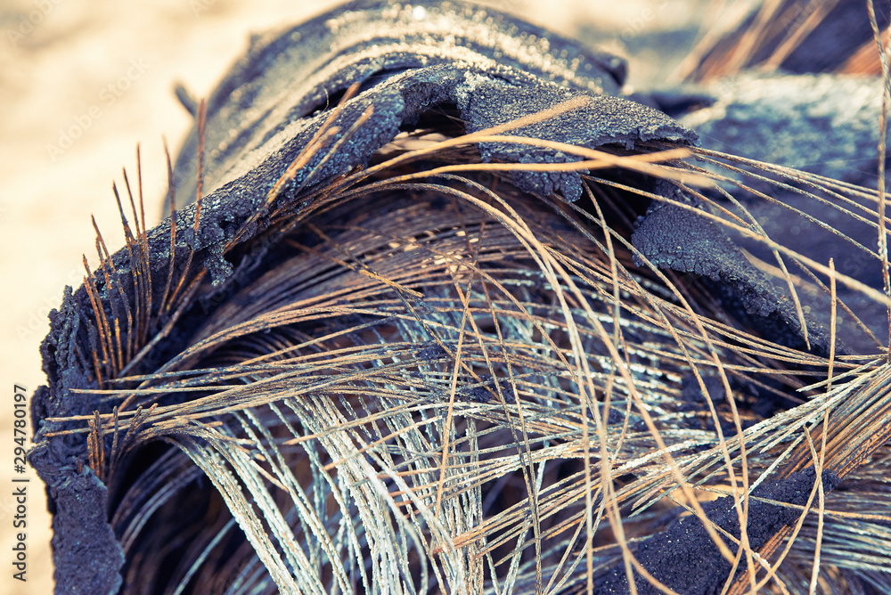 burnt tires. melted old rubber. metal rods stick out of the wheel. foto
