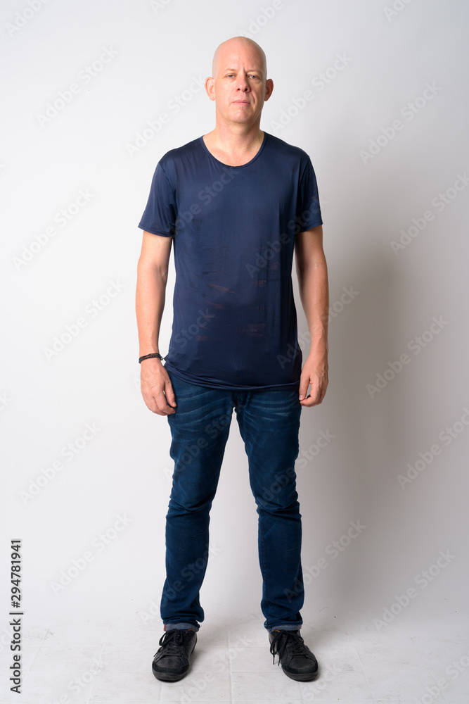 Full body shot of mature handsome bald man Full body shot of mature handsome bald man