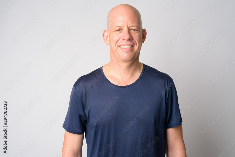 Portrait of happy mature handsome bald man smiling Portrait of happy mature handsome bald man smiling