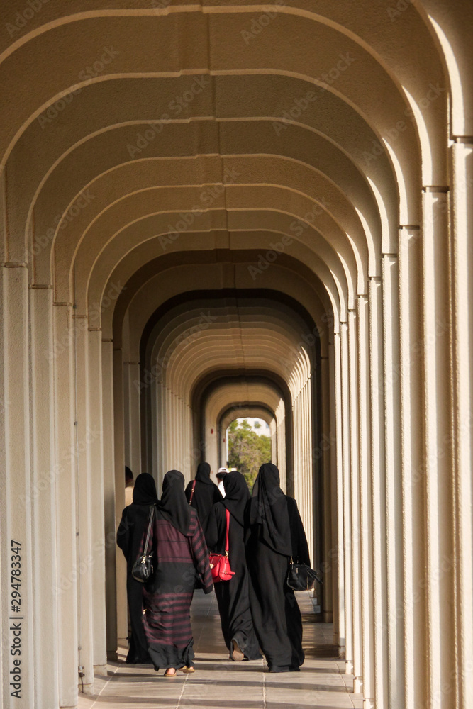 Muscat, Oman  Women in the hallways of the Sultan Qaboos University grounds.