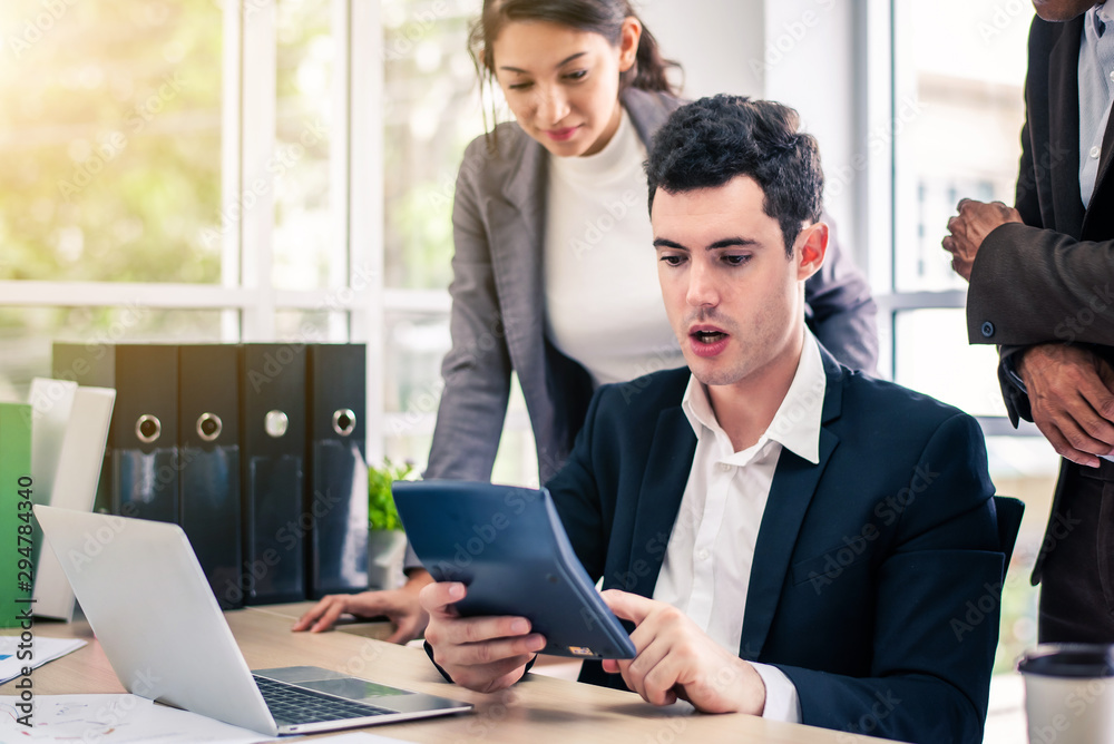 © totojang1977 - Businessman worry about his job with serious boss discussing while commenting a financial report document at meeting. business meeting concept.