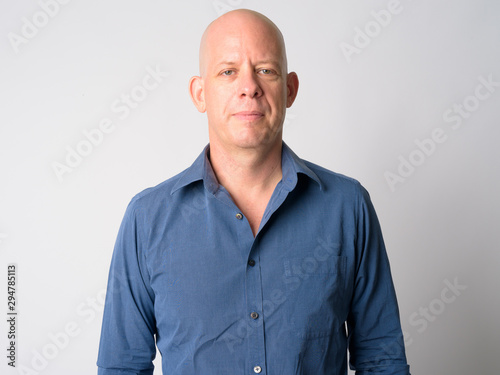 Face of mature handsome bald businessman looking at camera