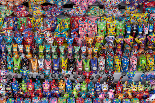 Sale of souvenirs - funny handmade wooden animals in street market. Bright colorful children toys and decoration for interior. Ubud  Bali island  Indonesia. Closeup