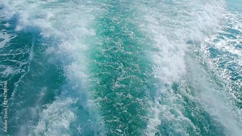 wave riple tails follow up to the speed boat showing wave and bubbles photo