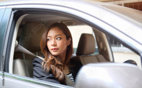 Close up portrait of a young business woman exiting a car