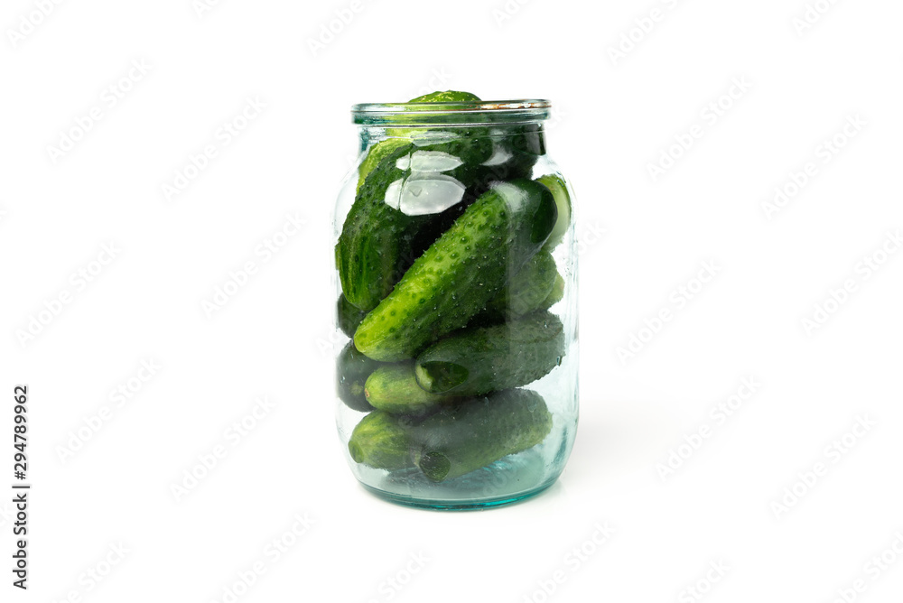 Fresh cucumbers in glass jar isolated on white background. Fresh cucumbers in glass jar isolated on white background.