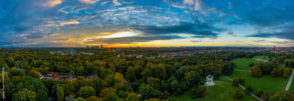 Obraz premium A beautiful start in the day. Sunset over Munichs English Garden as an aerial panorama shot.