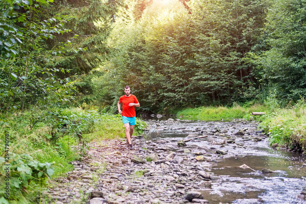 Young sportsman jogging in the beautiful sunset Young sportsman jogging in the beautiful sunset