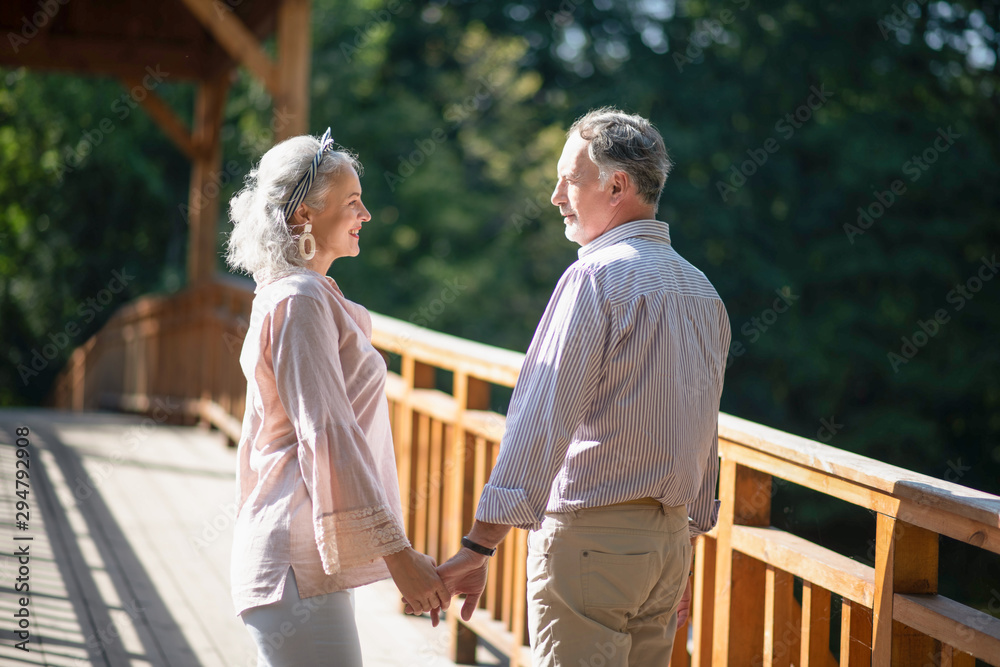 Beautiful grey-haired woman looking at her husband Beautiful grey-haired woman looking at her husband