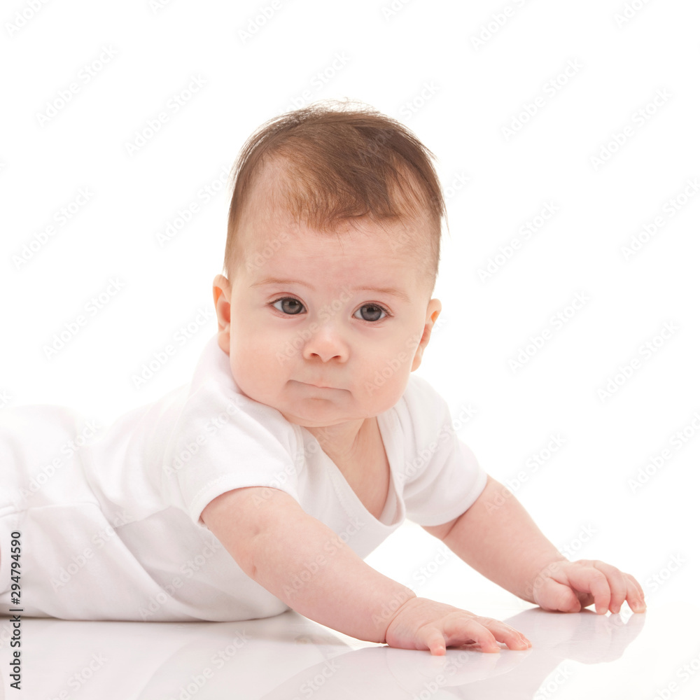Cute baby isolated on white background. Happy childhood. Close up portrait of happy baby. Fun kid in white pajama on white Cute baby isolated on white background. Happy childhood. Close up portrait of happy baby. Fun kid in white pajama on white