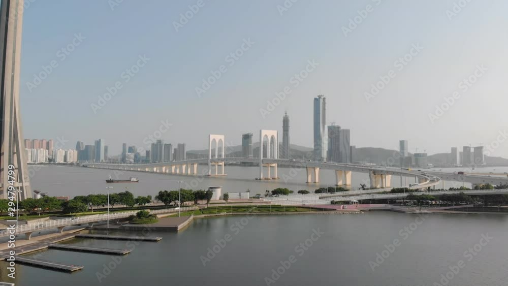 Drone approach shot of traffic crossing Sai Van Bridge in Macau and base of Macau Tower Drone approach shot of traffic crossing Sai Van Bridge in Macau and base of Macau Tower