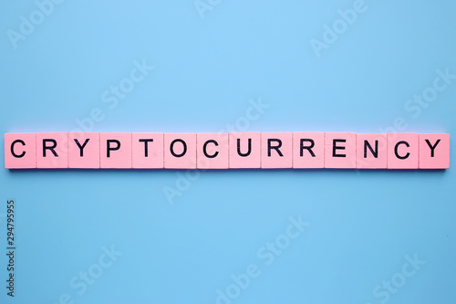 Cryptocurrency word wooden cubes on a blue background