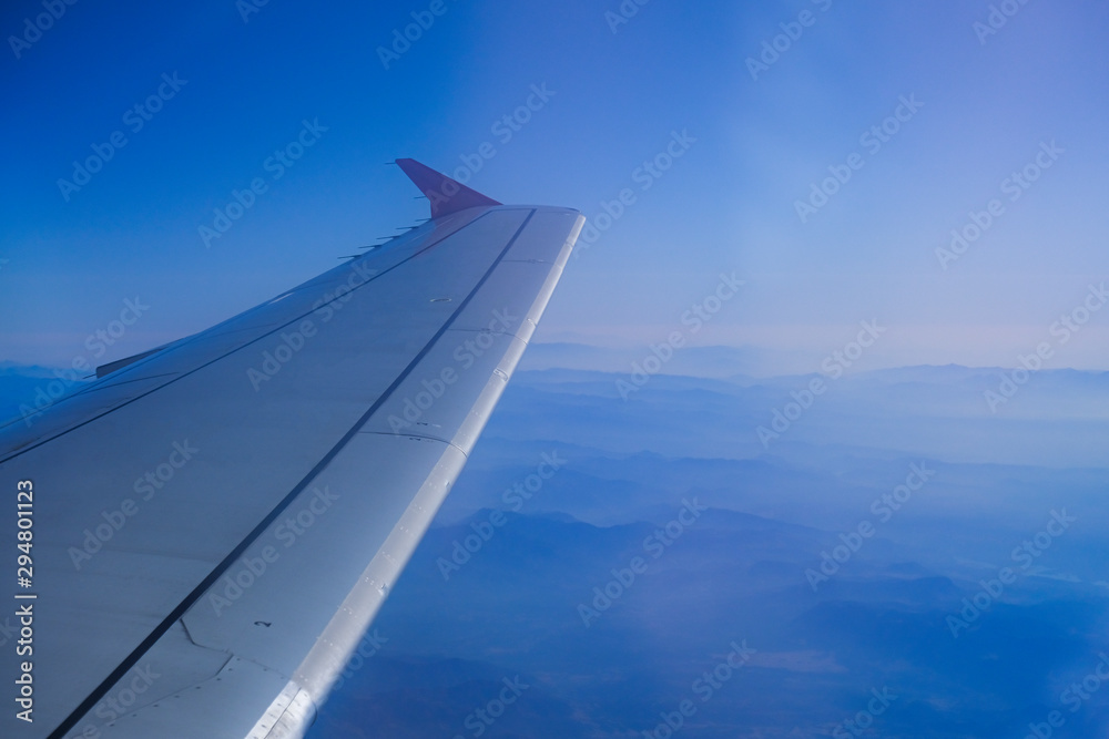 Plane wing in the sky over the mountains of Turkey