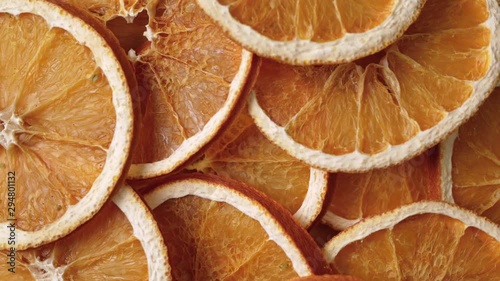 Dried slices of orange spinning around. Close up