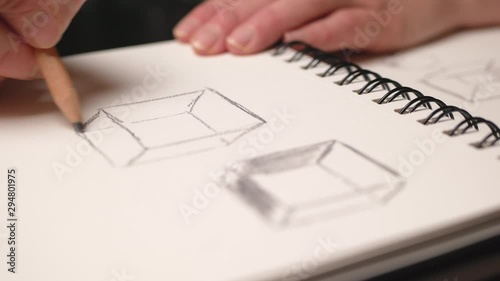 Woman hand drawing with pencil in the sketchbook. Close up. Slider movement