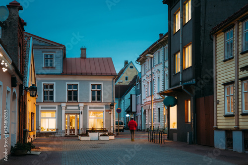 Parnu  Estonia. Night View Of Puhavaimu Street With Old Buildings  Houses  Restaurants  Cafe  Hotels And Shops In Evening Night Illuminations