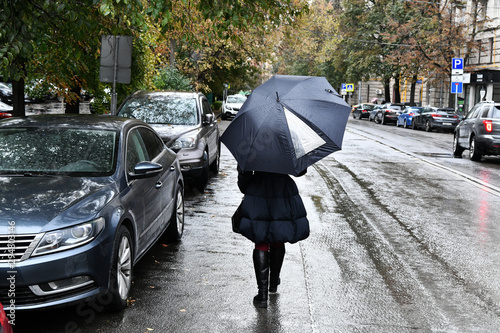 people with an umbrella walk in the rain