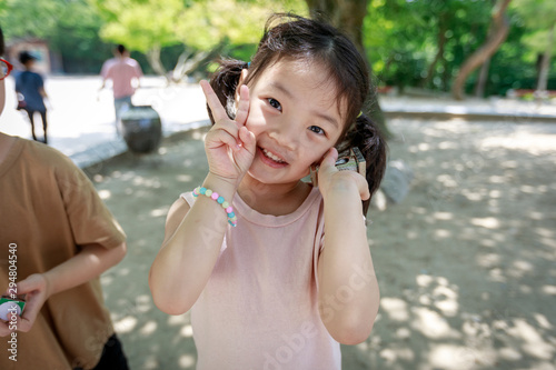 Kid showing v-sign and holding Cheomseongdae souvenir in Gyeongju