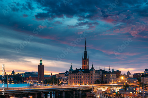 Stockholm, Sweden. Scenic View Of Stockholm Skyline At Summer Evening Night. Famous Popular Destination Scenic Place Under Dramatic Sky In Night Lights. Riddarholm Church, City Hall, Subway Railway