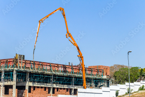 Construction Building Floor Concrete Pouring Mono Pumping Crane Extending High Mechanical Arm Outdoors.