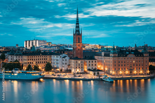 Stockholm, Sweden. Scenic View Of Stockholm Skyline At Summer Evening. Famous Popular Destination Scenic Place In Dusk Lights. Riddarholm Church In Night Lighting