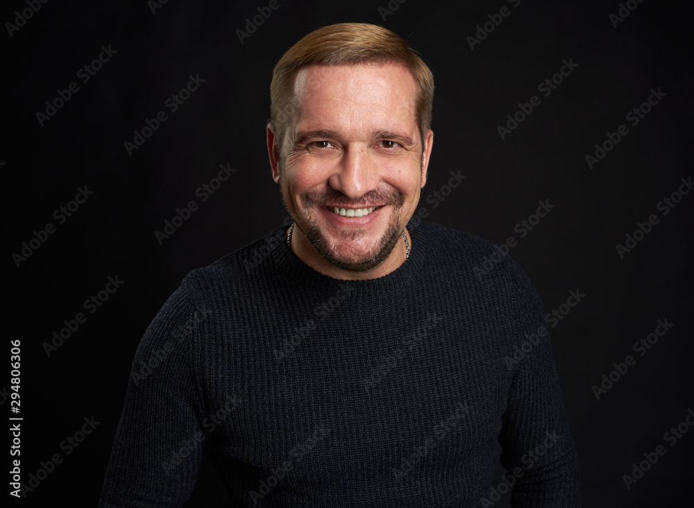 Studio shot of a happy man on black studio background