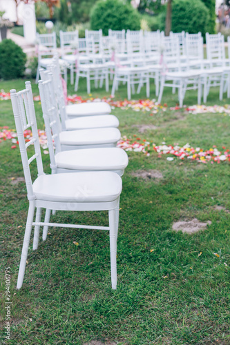 wedding or ceremony set up in garden, white chairs © ctvvelve