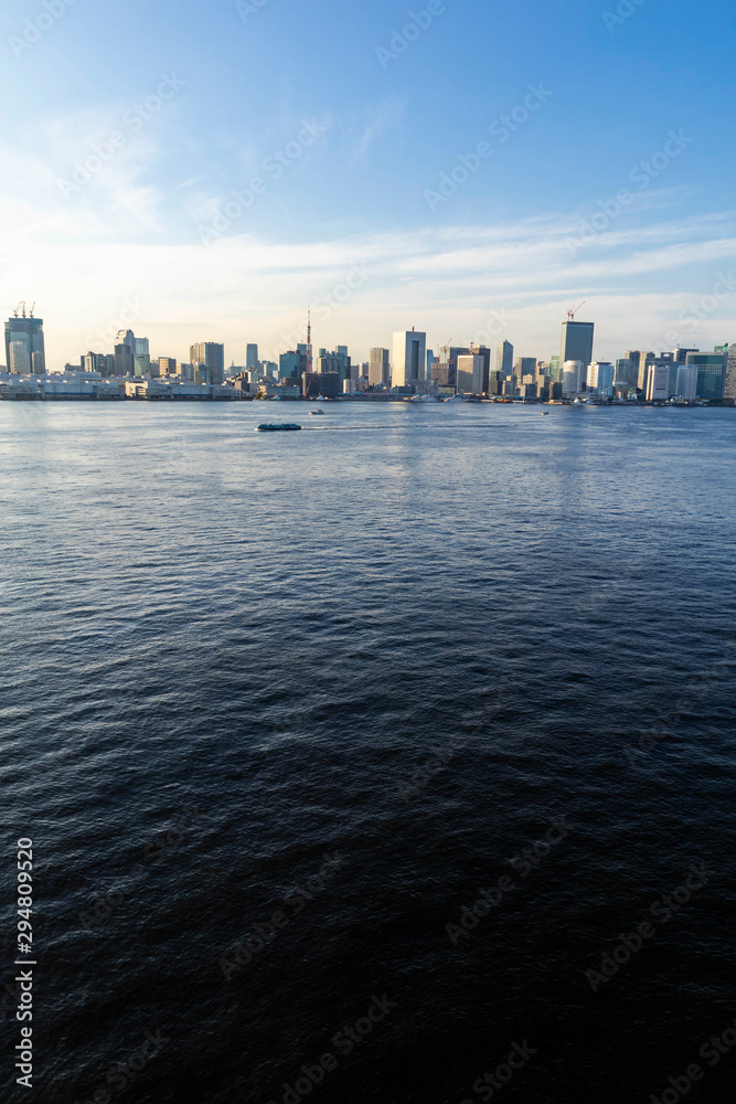 View of the Tokyo Bay during the day from the Rainbow Bridge in Odaiba. Busy waterway with ships. Landscape Orientation.