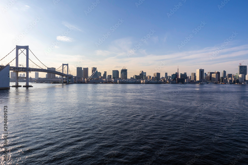 View of the Tokyo Bay during the day from the Rainbow Bridge in Odaiba. Busy waterway with ships. Landscape Orientation.