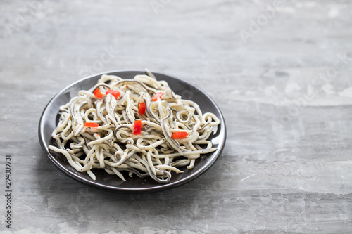Foto Traditional Spanish food. Gulas with oil on white plate.