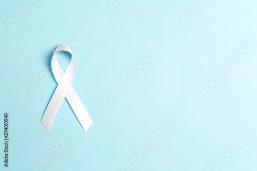 Lung cancer awareness ribbon on blue background.