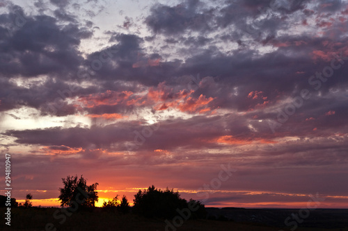 Beautiful colorful sunset over field. Nature landscape sunset background