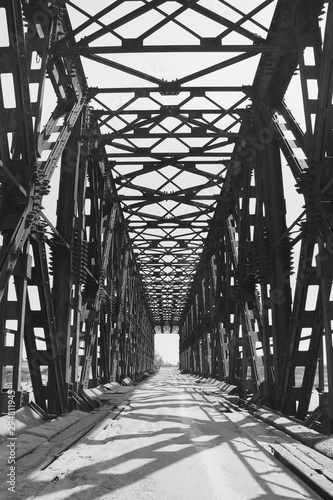 Fototapeta Naklejka Na Ścianę i Meble -  The metal bridge. Black and white photo. Old bridge