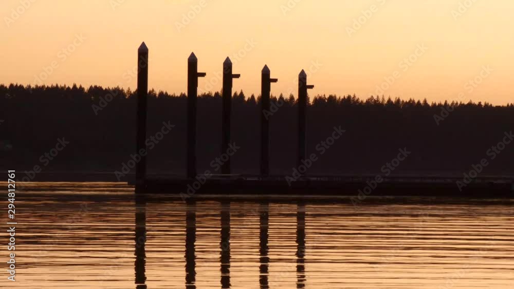 long pier leading out above the water at sunset long pier leading out above the water at sunset