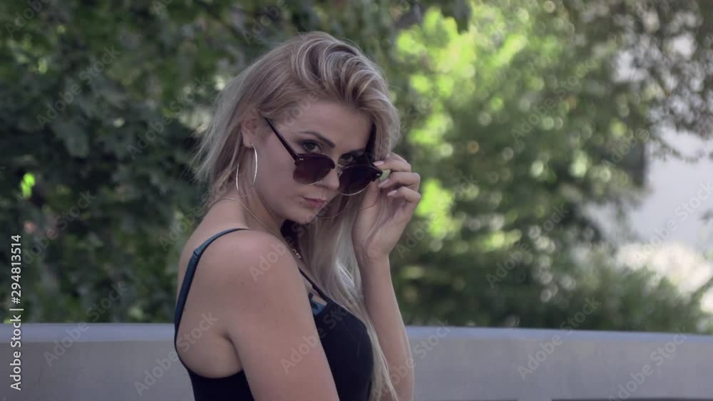Beautiful blonde in sunglasses and a black jacket Beautiful blonde in sunglasses and a black jacket