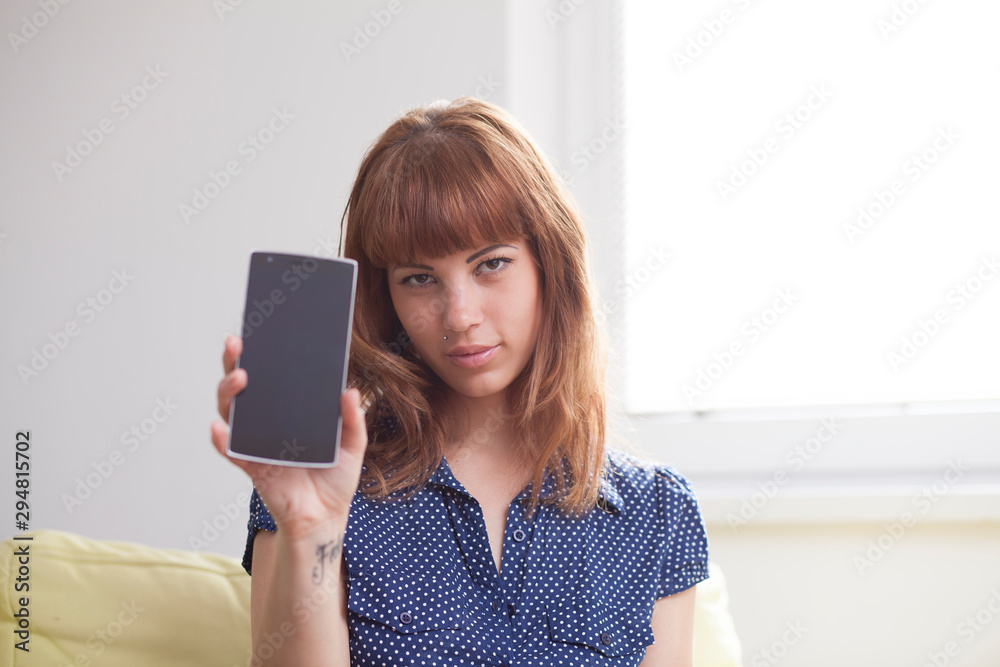 Naklejka premium Woman showing mobile phone screen