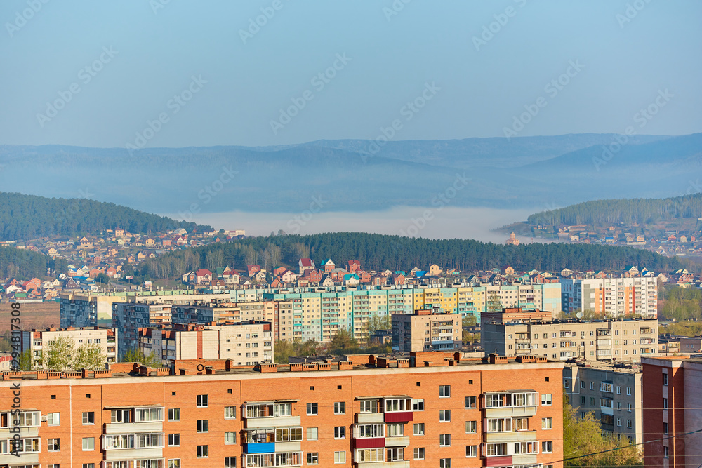 Residential complex in the Northern part of Miass, Russia. In the background, the Ural mountains, Ilmen ridge and the village of Turgoyak, near lake Turgoyak.