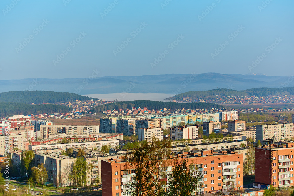 Residential complex in the Northern part of Miass, Russia. In the background, the Ural mountains, Ilmen ridge and the village of Turgoyak, near lake Turgoyak