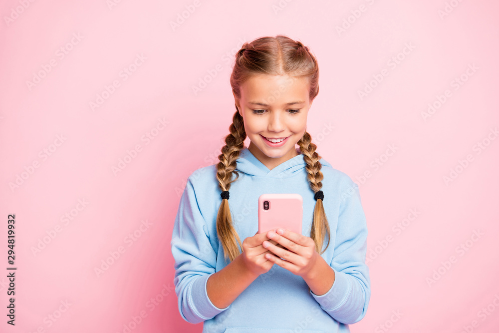 Photo of pretty little lady holding telephone hands reading positive comments for new post wear casual blue hoodie pullover isolated pastel pink color background - obrazy, fototapety, plakaty 