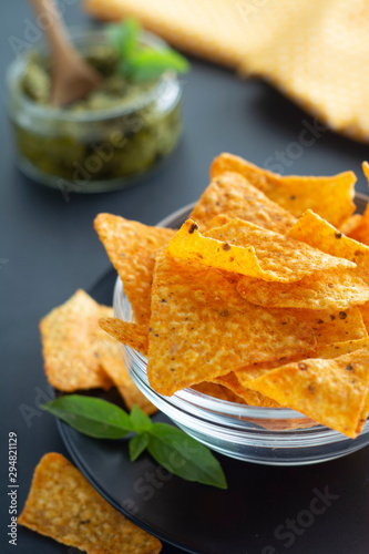Nachos chips or corn mexican chips in glass bowl  isolated healthy food snack