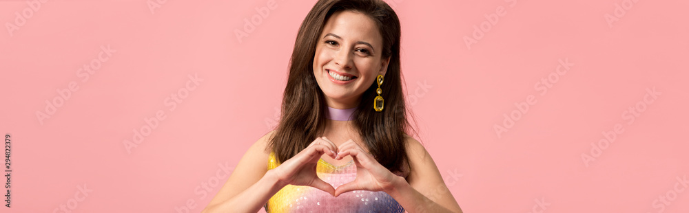 panoramic shot of happy young stylish disco girl showing heart gesture isolated on pink panoramic shot of happy young stylish disco girl showing heart gesture isolated on pink