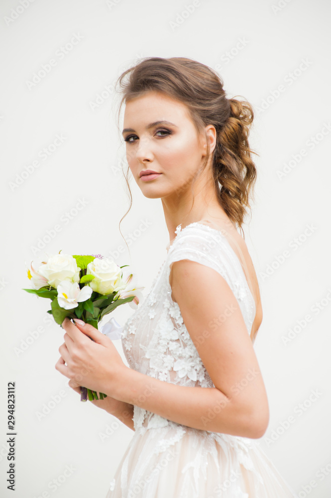 Beautiful happy bride in long wedding dress with wedding bouquet Beautiful happy bride in long wedding dress with wedding bouquet