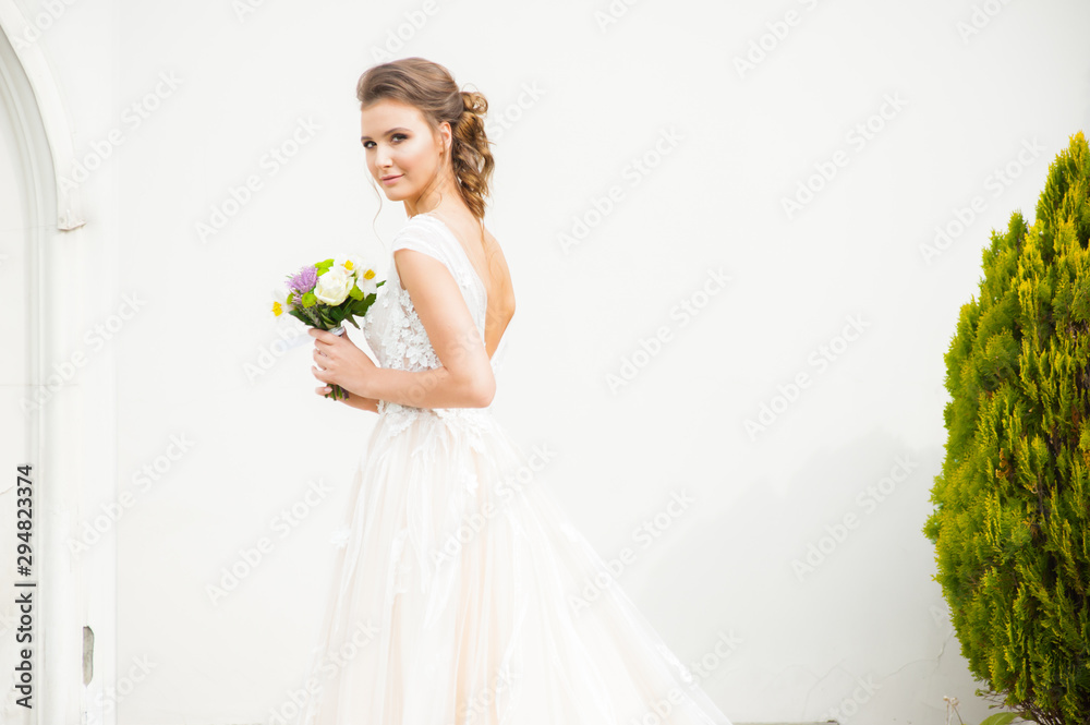 Bride in long wedding dress with bouquet outdoor Bride in long wedding dress with bouquet outdoor